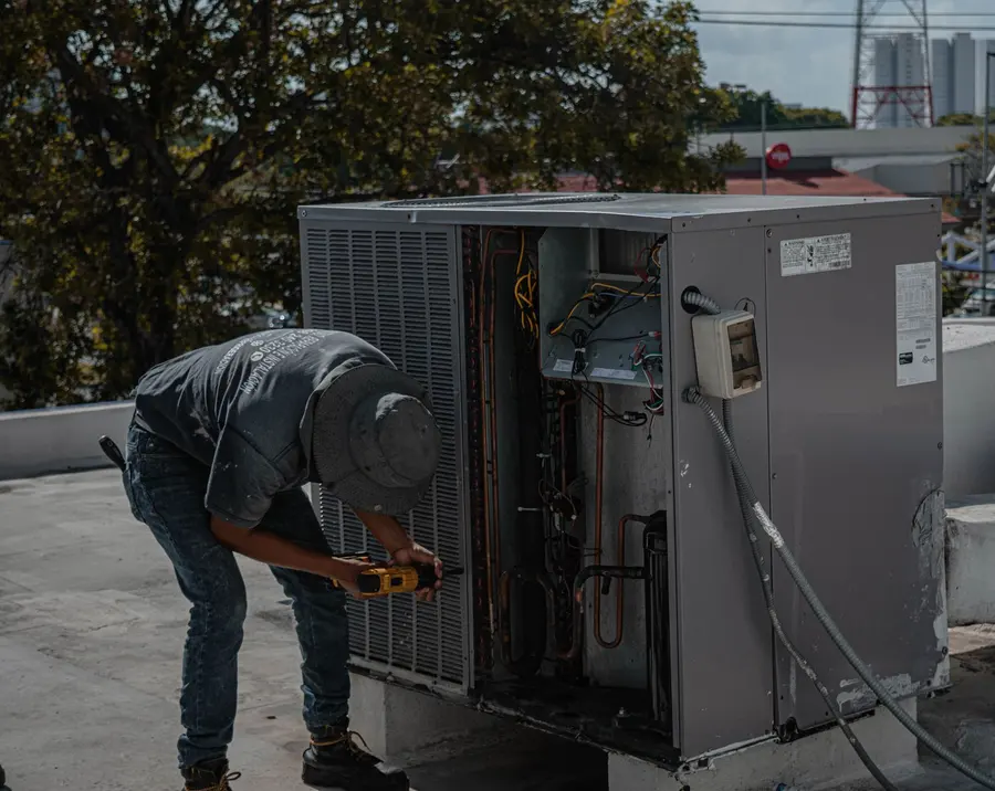 Technician checking a rooftop HVAC unit