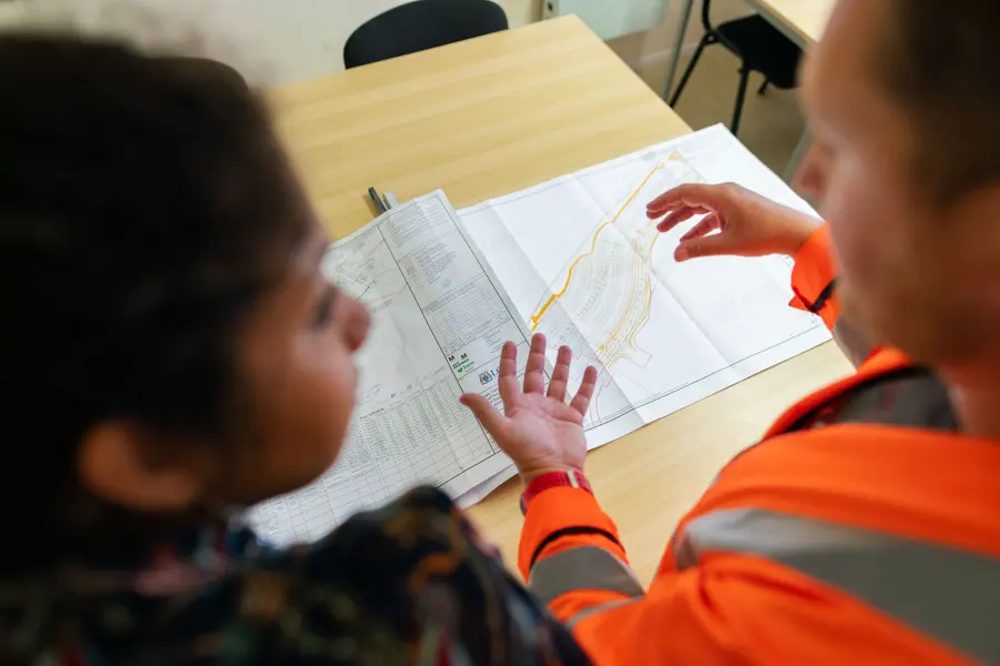 Two technicians reviewing a drawing