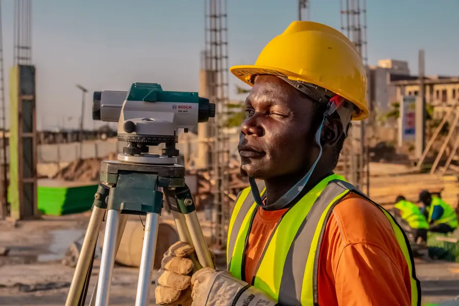 Surveyor with an optical level on a construction site